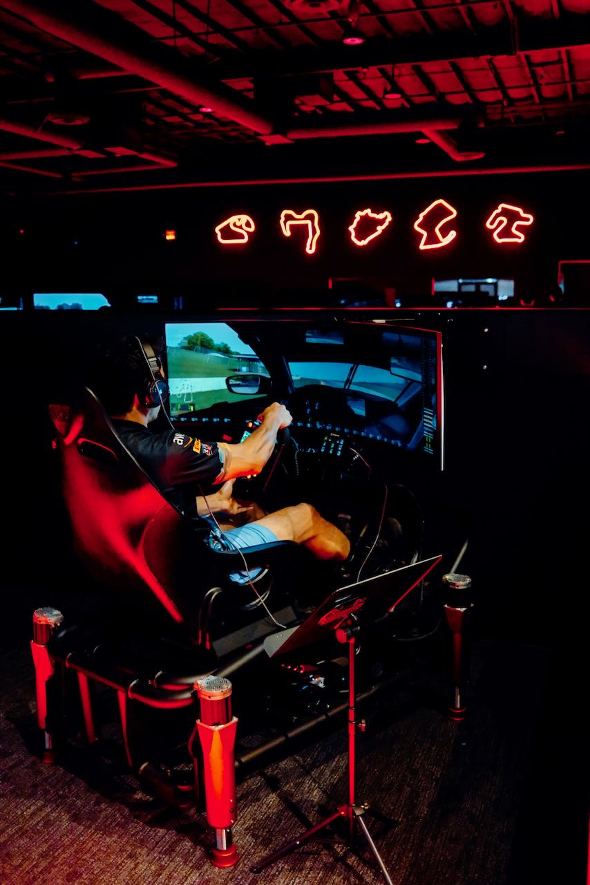 Esports sim rig with 3-axis motion base and widescreen monitor