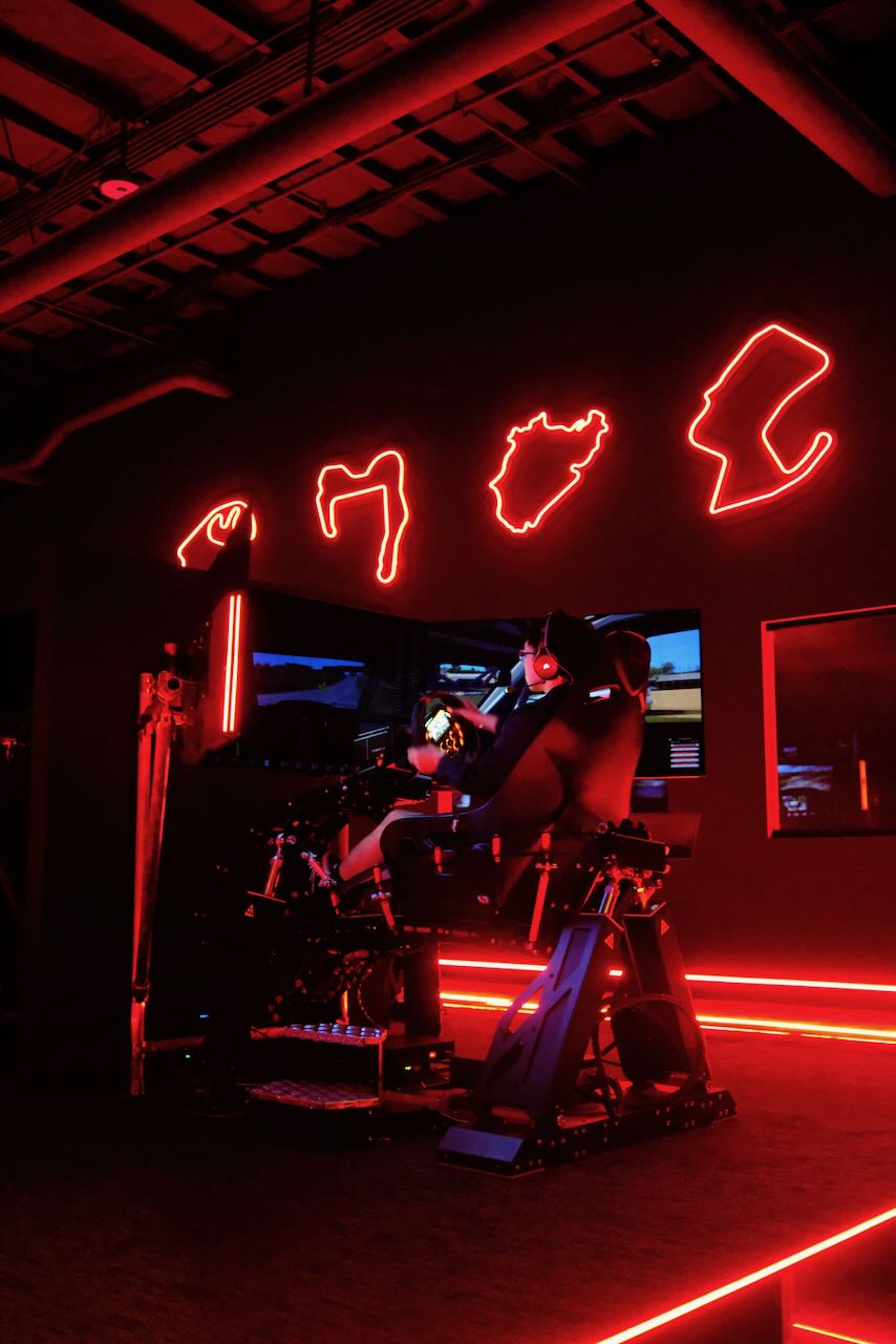 Pro sim rig with 4-axis motion base and triple-monitor setup
